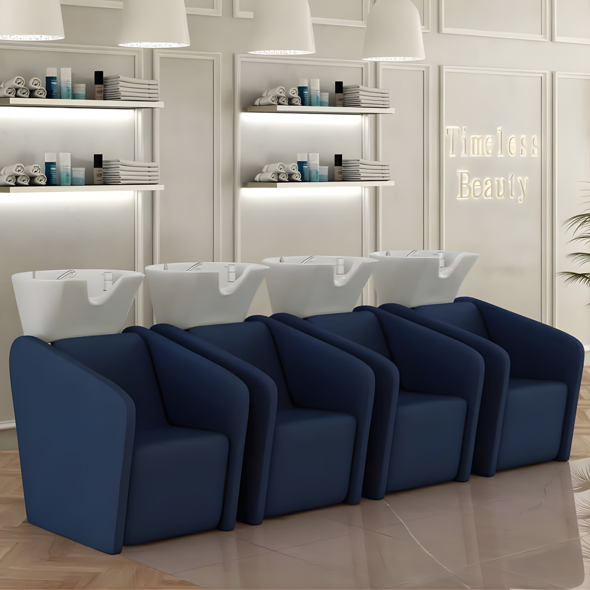 moderni frizerski salon s četiri plava glavopera i bijelim umivaonicima, u prostoru sa svijetlim zidovima i color barom u pozadini